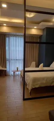 a bedroom with a bed and a large mirror at Megaworld in Manila