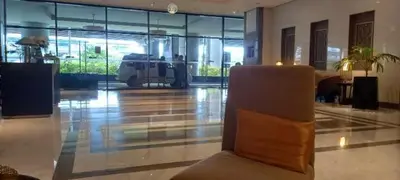 a lobby with a chair in the middle of a building at Megaworld in Manila
