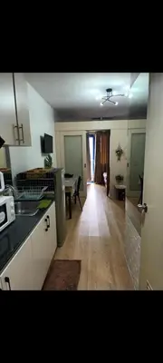 a kitchen and living room with a table in it at Sea Residences Crisha in Manila