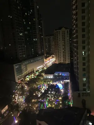 a city street filled with christmas lights at night at Cozy House BGC 1BR up to 6 Guests 100MBPS WiFi in Manila