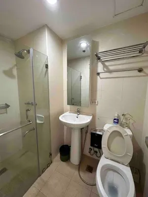 a bathroom with a shower and a toilet and a sink at Cozy House BGC 1BR up to 6 Guests 100MBPS WiFi in Manila