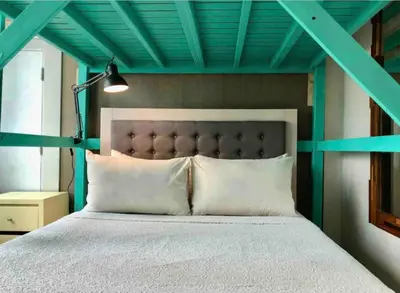 a bedroom with a bed with a blue ceiling at Cozy House BGC 1BR up to 6 Guests 100MBPS WiFi in Manila