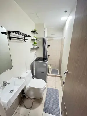 a bathroom with a toilet and a sink at Amber's Crib in Manila