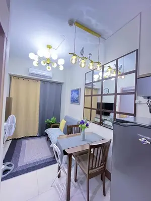 a kitchen and living room with a table and a dining room at Amber's Crib in Manila