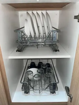 a shelf in a refrigerator with glasses on it at Amber's Crib in Manila