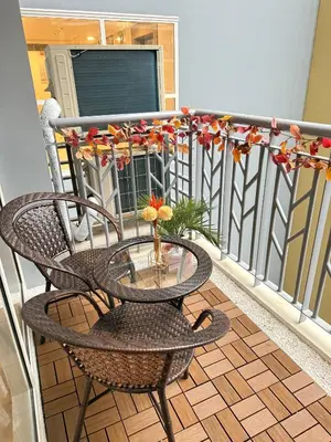 a balcony with a table and chairs on a balcony at Kuya Awens Staycation in Manila