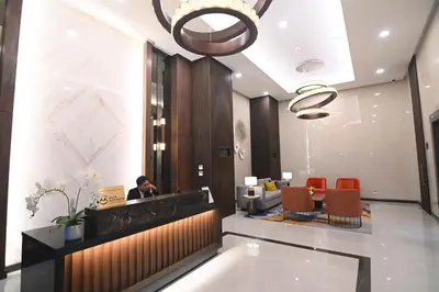 a man sitting at a desk in a lobby at Kuya Awens Staycation in Manila