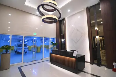 a lobby with a reception desk and a chandelier at Kuya Awens Staycation in Manila