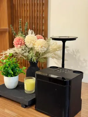a black cpu sitting on top of a table with flowers at 1-BR condo unit near Rockwell, Poblacion in Manila