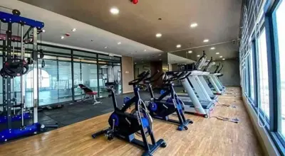 a gym with treadmills and elliptical machines at 1-BR condo unit near Rockwell, Poblacion in Manila