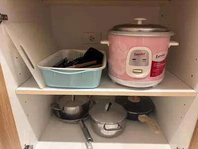 a cupboard with a kitchen utensils and a pot at Charming Unit at Smdc Sun Residences in Manila