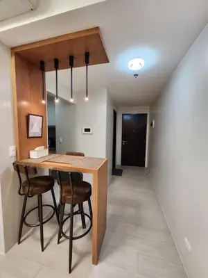 a dining room with a wooden table and chairs at Cozy Condo Unit Near NAIA Terminal 3 in Manila