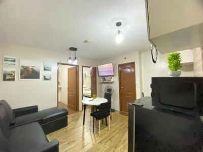 a living room with a couch and a table at Your Comfort Zone Staycation3 in Manila