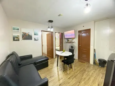 a living room with a couch and a table at Your Comfort Zone Staycation3 in Manila