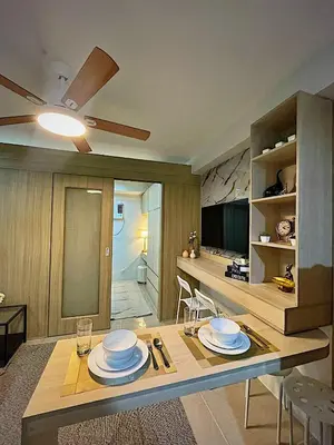a kitchen with a table with plates on it at Shore 1 Residences - ÜniQa Suite - MOA Area in Manila