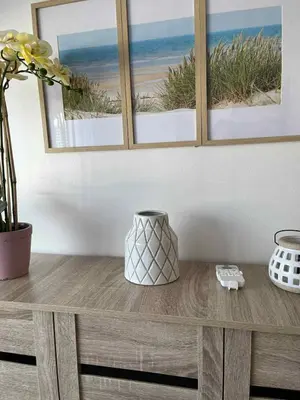 a wooden table with a picture of the beach at South Residences Tower 4, Las Pinas in Manila