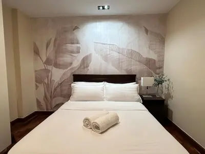 a bedroom with a bed with a towel on it at Stylish 100 SQM 3BR Loft Near Greenbelt Makati in Manila