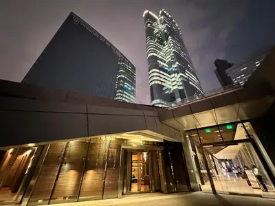 a building with two tall skyscrapers at night at Stylish 100 SQM 3BR Loft Near Greenbelt Makati in Manila
