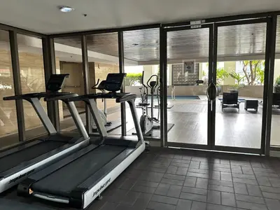 a gym with treadmills and ellipticals in a room at Huge 100-SQM 3BR Loft near Greenbelt Makati in Manila