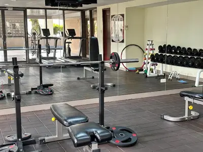 a gym with a lot of equipment in it at Huge 100-SQM 3BR Loft near Greenbelt Makati in Manila