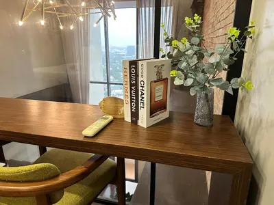 a book sitting on a table with a remote control at 100 SQM 3BR in Central Makati Greenbelt Area in Manila