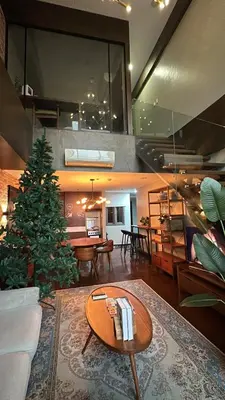 a living room with a christmas tree and a table at 100 SQM 3BR in Central Makati Greenbelt Area in Manila