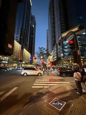 a busy city street at night with cars and traffic lights at Executive Suites 4 Bedroom Condo Uptown Parksuites Bgc in Manila