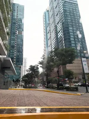 a street in a city with tall buildings at Executive Suites 4 Bedroom Condo Uptown Parksuites Bgc in Manila