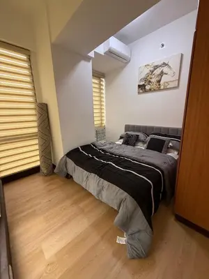 a bedroom with two twin beds in a room at Executive Suites Bellagio Golf View Residences in Manila
