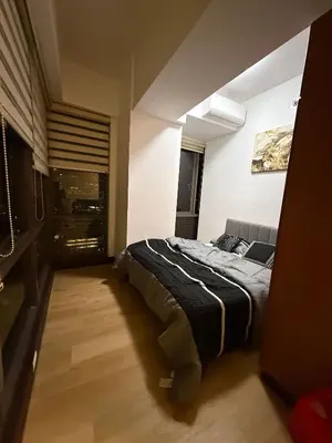 a bedroom with a bed in the middle of it at Executive Suites Bellagio Golf View Residences in Manila
