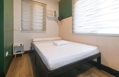 a hospital bed in a room with a window at Maine Residences Leveriza by RedDoorz in Manila