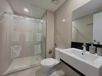 a bathroom with a toilet and a shower and a sink at PREMIUM 1BR Venice Canal Mall, Pool, Gym, Sauna & 5G Wi-Fi, Ste 16 in Manila