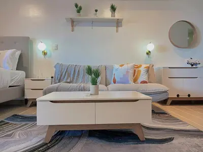 a living room with a couch and a coffee table at PREMIUM 1BR Venice Canal Mall, Pool, Gym, Sauna & 5G Wi-Fi, Ste 16 in Manila
