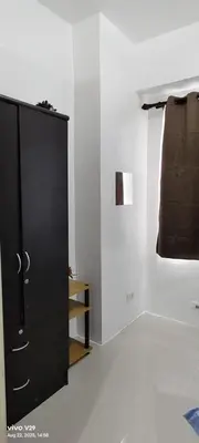 a black cabinet in a white room with a window at Graxia staycation in Manila