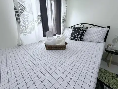 a bedroom with a bed with a basket on it at Cozy Place to Stay in Manila