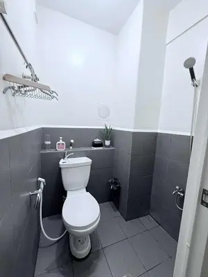a bathroom with a white toilet and a shower at Cozy Place to Stay in Manila