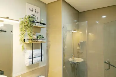 a bathroom with a shower and a toilet and a sink at Breathtaking Eastwood City View, 3min walk to Malls, with Washer in Manila