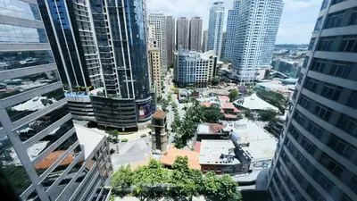 an aerial view of a city with tall buildings at Breathtaking Eastwood City View, 3min walk to Malls, with Washer in Manila