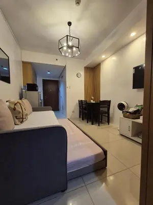 a bedroom with a bed and a dining room at Family Suite with Big Balcony and Pool View in Manila