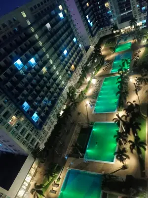 an aerial view of a city at night at SEA RESIDENCES Golden in Manila