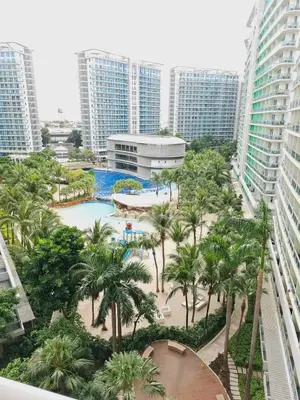 a view of a resort with a pool and palm trees at Affordable Boracay-like Staycation in Azure South in Manila