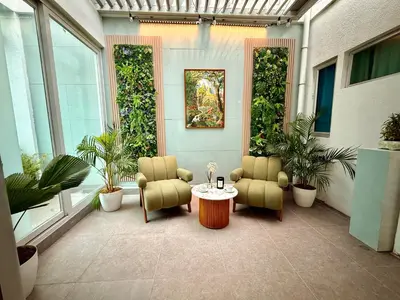 a patio with two chairs and a table and plants at Elegant 4BR penthouse in BGC in Manila