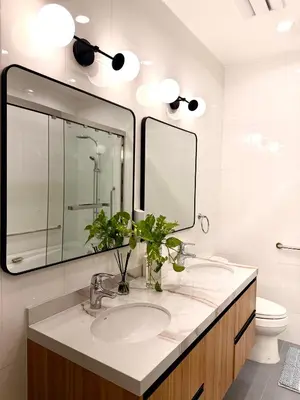 a bathroom with a sink and a mirror and a toilet at Elegant 4BR penthouse in BGC in Manila