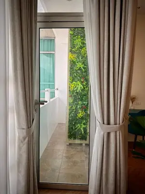 a sliding glass door leading to a garden at Elegant 4BR penthouse in BGC in Manila