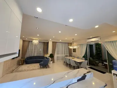 a large living room with a couch and a table at Elegant 4BR penthouse in BGC in Manila