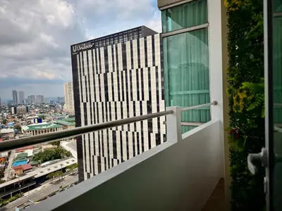 a balcony with a view of a tall building at Elegant 4BR penthouse in BGC in Manila