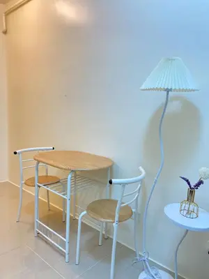 a table and two chairs and a lamp in a room at Walk to Araneta, MRT and Malls, Cubao, Netflix in Manila