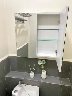 a bathroom with a sink and a mirror at Walk to Araneta, MRT and Malls, Cubao, Netflix in Manila