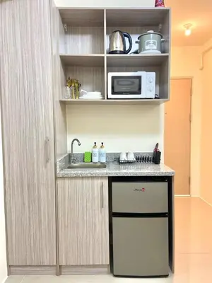 a kitchen with a sink and a microwave at Walk to Araneta, MRT and Malls, Cubao, Netflix in Manila