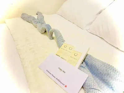 a hotel bed with a price tag on it at Shore Residences in Manila
